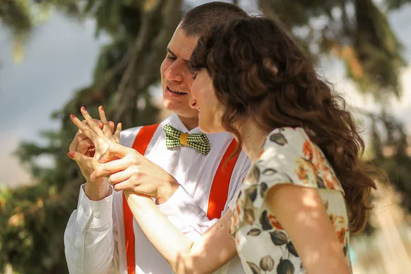 Jonge mooie paar spelen en lachen in de buurt van een teken van liefde — Stockfoto