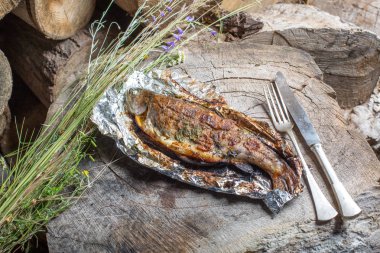 Bir alüminyum folyo üzerinde ızgara bütün alabalık 