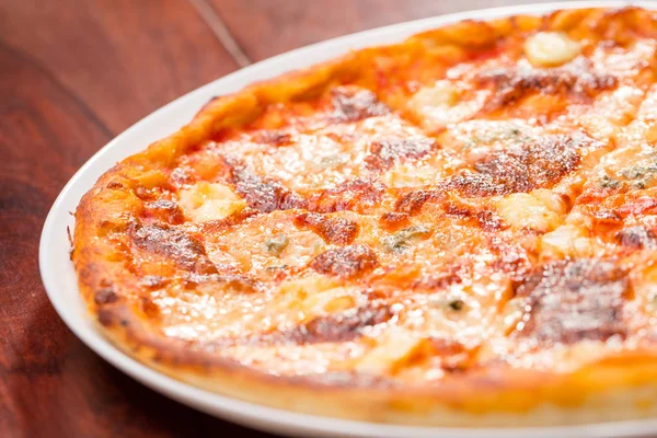 Four cheese pizza top view with wooden table