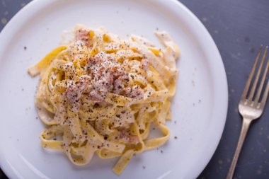 arka plan beyaz bir tabak makarna carbonara, yakın çekim