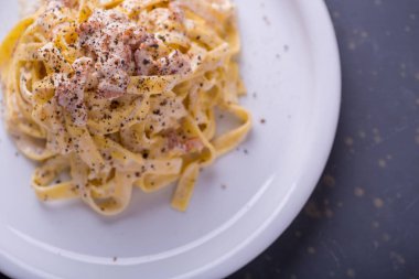 arka plan beyaz bir tabak makarna carbonara, yakın çekim