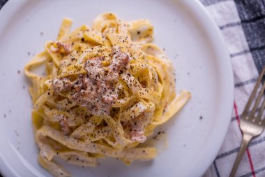 arka plan beyaz bir tabak makarna carbonara, yakın çekim