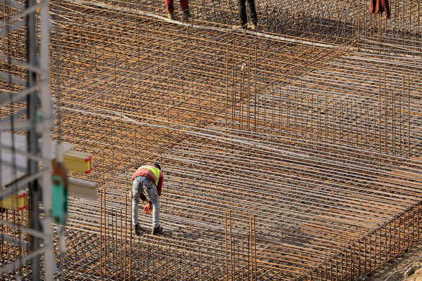 Men working at steel frames on a construction site