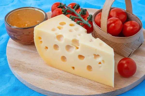 チーズプレートには トマトと蜂蜜の三角形のチーズが添えられています — ストック写真