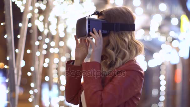 Woman uses a virtual reality glasses on abstract background — Stock Video