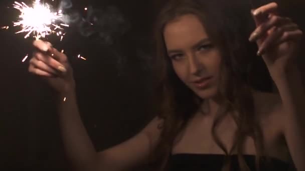 Portrait of attractive girl with sparklers. cute beautiful girl dancing at the party — Stock Video