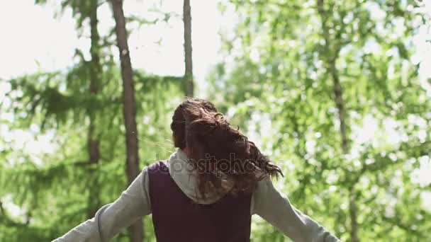 Attractive girl raises her arms up and rejoices at the completed training session. young girl Jogging. athlete joyfully lifts his hands in the end of the workout. slow motion — Stock Video