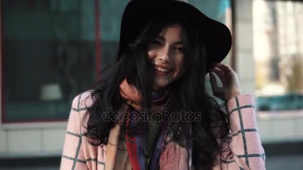 Closeup portrait of beautiful young woman in autumn coat against the background of modern architecture. girl sensually looking at the camera. — Stock Video