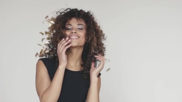 Hispanic woman celebrating party with sparkling dancing gold glitter background. concept of the holiday, fun, celebrate. slow motion — Stock Video