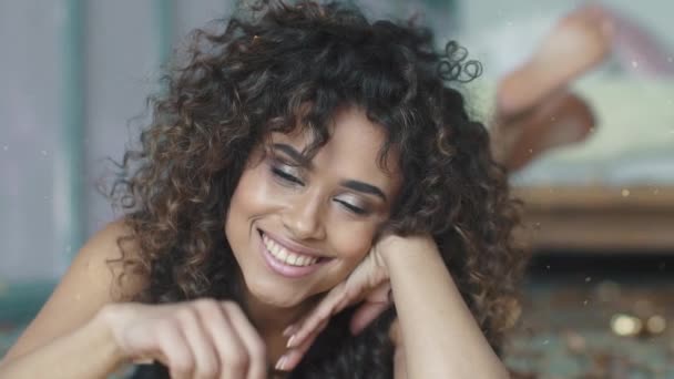 Portrait of a young hispanic woman with a stunning smile. multiethnic girl with sparkles and tinsel. concept of the holiday, fun, celebrate. slow motion — Stock Video