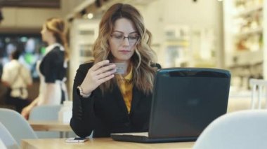 genç kadın Internet üzerinde satın almak için kredi kartı ile öder