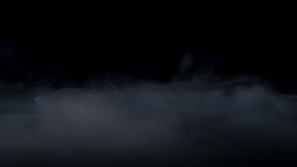 Fog effect. Atmospheric smoke. Haze background. Abstract smoke cloud. White smoke slowly floating through space against black background — ストック動画