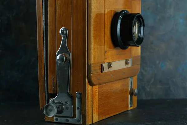 Vintage wooden camera on a cement background.