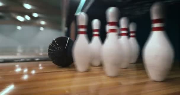 Bowling strike, bowling ball knocks down bowling pins in slow motion — Stock Video