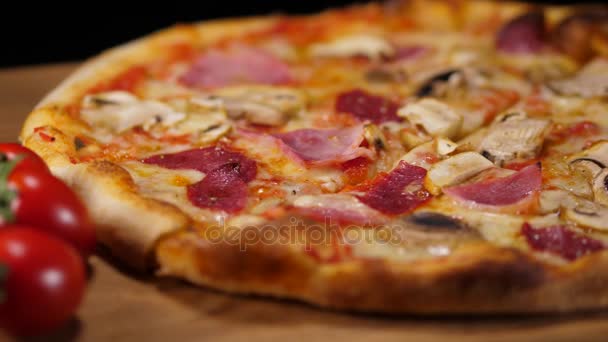 Hot pizza with ham and tomatoes
