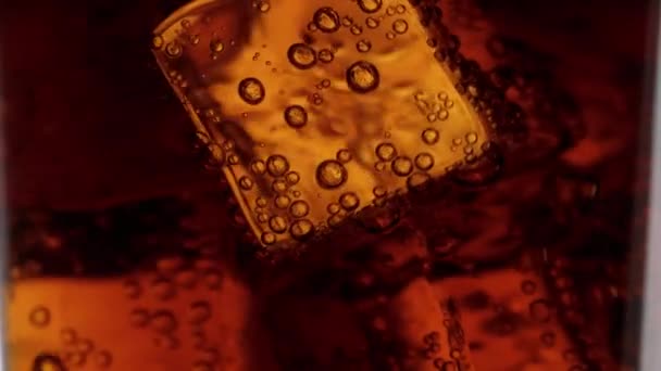 Close up shot of Cola on ice in slow motion — Videoclip de stoc