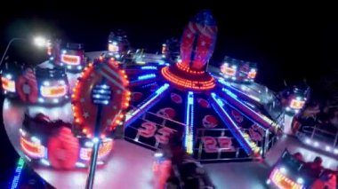 Carousels at amusement fair at night - CARDIFF, WALES - DECEMBER 31, 2019