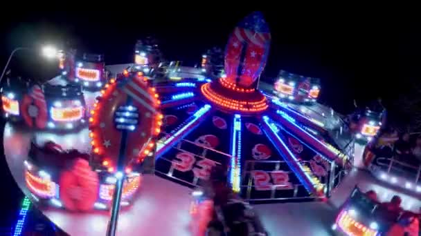 Carousels at amusement fair at night - CARDIFF, WALES - DECEMBER 31, 2019 — Stok video