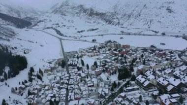 Flight over the famous village of Andermatt in Switzerland in winter