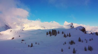 Flight over a snowy mountains in winter - wonderful Swiss Alps - aerial photography