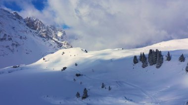 Flight over a snowy mountains in winter - wonderful Swiss Alps - aerial photography