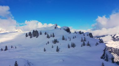 Great winter landscape - flight over snow capped mountains - aerial photography