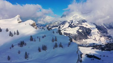 Great winter landscape - flight over snow capped mountains - aerial photography