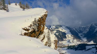 Flight over a snowy mountains in winter - wonderful Swiss Alps - aerial photography