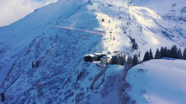 Flight over a snowy mountains in winter - wonderful Swiss Alps - aerial photography
