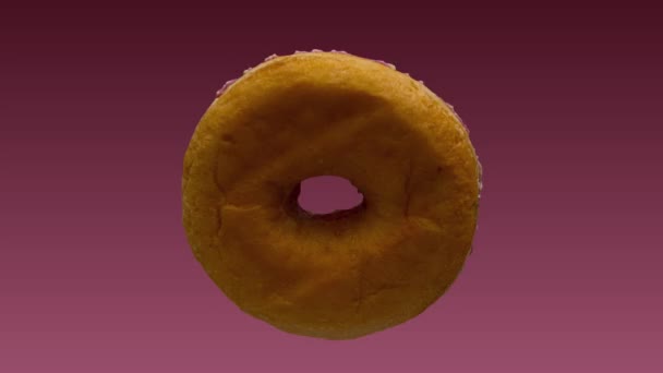 Donut - close-up van een roze donut stop trick shot — Stockvideo