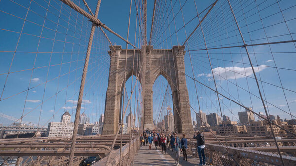 A famous tourist attraction in New York - The Brooklyn Bridge - NEW YORK CITY, UNITED STATES - APRIL 2, 2017