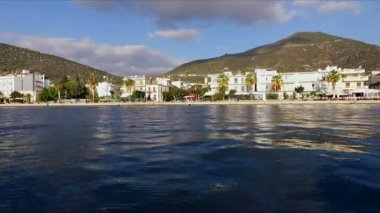 Sabah Yunan boş Marina, metan. Hava video çekim. Boş bir iskele. Arka planda dağlar ve şehir evleri manzara var. Yaz Açık sabah, mavi gökyüzü bulutlu