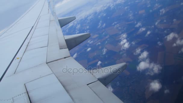 飛行機の窓からの眺め、見ることができる牧草地、フィールド、雲、飛行機の翼の風景。鳥の目のビュー — ストック動画