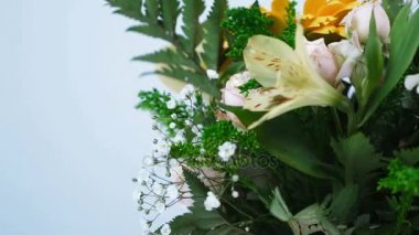 yakın çekim. Çiçek, buket, beyaz arka plan, rotasyon çiçek kompozisyon oluşur gerbera gül pion şeklinde, Alstroemeria, solidago, gypsophila, Arachniodis.