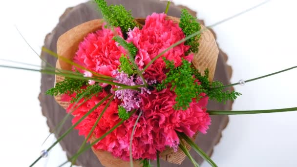 Top view, close-up of a bouquet of flowers, rotation on a white background. The flower arrangement consists of Carnation, Barbatus. — Stock Video