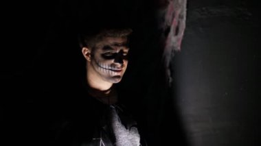 Alacakaranlık, ışık ışınları bir adam portresi korkutucu Cadılar Bayramı partisi, iyi geceler. adam siyah cadı kostüm korkunç bir makyaj ile