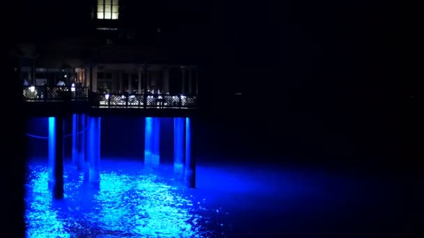 阿联酋迪拜, 阿拉伯联合酋长国-2017年11月20日: 酒店朱美拉, 晚上, 在水是码头上的餐厅。水从背光光中闪耀 — 图库视频影像