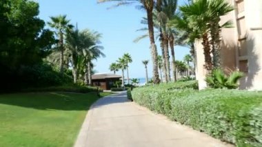 Dubai, Birleşik Arap Emirlikleri, Birleşik Arap Emirlikleri - 20 Kasım 2017: Otel Jumeirah Al Qasr Madinat, sabah yürüyüşü otel çevresinde otobüs böceğe, hepsi yeşil güneş vardır