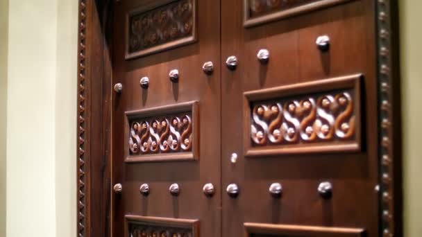 Dubai, Verenigde Arabische Emiraten, Verenigde Arabische Emiraten - 20 November 2017: Hotel Jumeirah Al Qasr Madinat, mooi gesneden houten deuren in een hotelkamer, close-up — Stockvideo