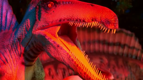 DUBAI, UNITED ARAB EMIRATES, UAE - NOVEMBER 20, 2017: Dinosaur Park at Dubai Garden Glow park, illuminated at night. a lot of different dinosaurs, look alive — Stock Video