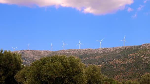 Wind power station - wind turbine against the blue sky. eco wind power generators. Greece. summer — Stock Video