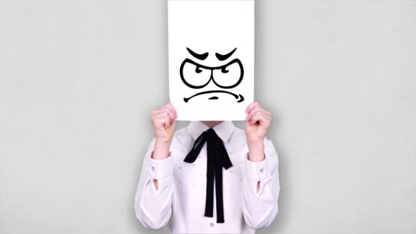 Portrait, teenager holds white paper sheet with disappointed smiley drawing, animation, covering face. emotions, Imagination, creativity, successful idea concept. — Stock video