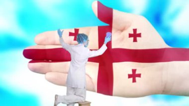 Tıbbi maskeli ve eldivenli hemşire, Georgia bayrağı renginde boyanmış büyük elleri yıkıyor. Ulusal sağlık hizmetleri. Ellerinizi yıkayın. Virüs koruması. Hastalıkların önlenmesi.