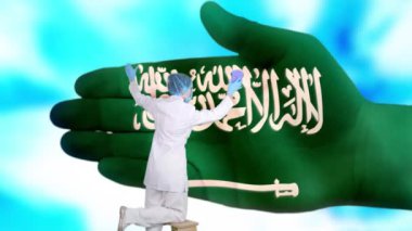 Tıbbi maskeli ve eldivenli hemşire, Suudi Arabistan bayrağı renginde boyanmış büyük elleri yıkıyor. Ulusal sağlık hizmetleri. Ellerinizi yıkayın. Virüs koruması. Hastalıkların önlenmesi.