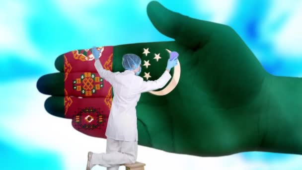 Nurse in medical mask and gloves washes large hand, painted in colors of Turkmenistan flag. State care for nation health. Wash your hands concept. Viruses protection. Diseases prevention. — Stock Video