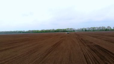 CHERKASY, UKRAINE, 28 NİSAN 2020: Aero, İHA videosu. Traktör bahar zamanı mısır tohumu ekiyor. Böcek ilacıyla tedavi edilmiş mısır ekiyorum. Döllenmiş toprağa mısır ekmek..