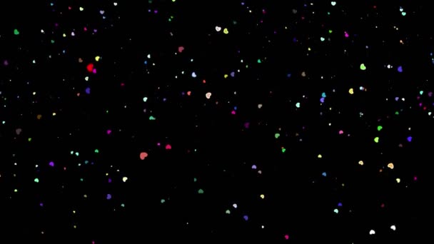 fond magique festif. Twinkling, scintillant, coloré, particules en forme de coeur tombant sur fond noir. Volant, scintillant, particules en forme de coeur scintillent  .