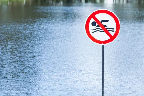 lake with prohibited sign swimming