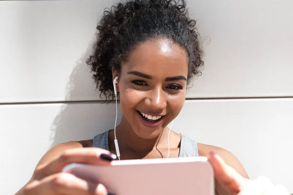 Young smiling woman live streaming from her mobile phone