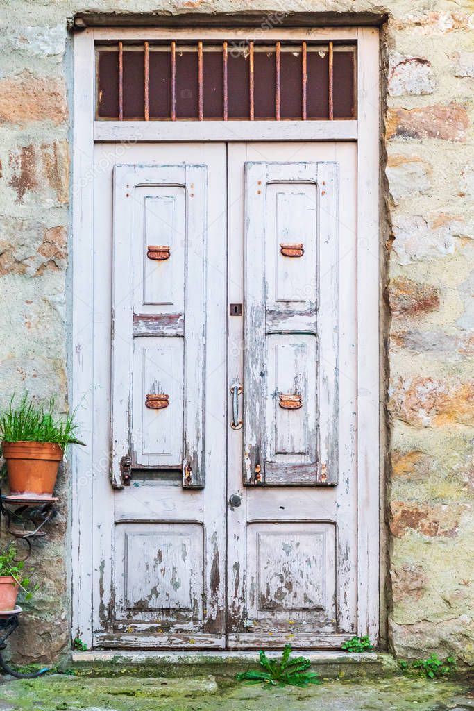 Italy, Sicily, Palermo Province, Pollina. Old wooden door on a stone building in the town of Pollina.